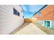 Concrete driveway between houses with gate in back for privacy at 1345 S Meade St, Denver, CO 80219