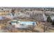 Aerial view of a park featuring a swimming pool and a serene lake, perfect for leisure and recreation at 1345 S Meade St, Denver, CO 80219