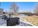 Large backyard with a grill, patio furniture, and a lawn with some snow cover at 11363 Jersey St, Thornton, CO 80233