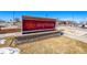 Close-up of a contemporary business sign on a landscaped base, enhancing curb appeal in a commercial area at 11363 Jersey St, Thornton, CO 80233