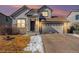 Charming two-story home with a well-maintained lawn and stone accents at 11363 Jersey St, Thornton, CO 80233