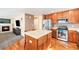 Open-concept kitchen with stainless steel appliances and views of the Gathering room at 11363 Jersey St, Thornton, CO 80233