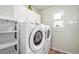 Bright laundry room with a side-by-side washer and dryer, white cabinets, and a window at 11363 Jersey St, Thornton, CO 80233