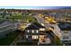 Stunning aerial view of a two-story home with solar panels, a patio and a shared green space at 12264 Olive Way, Thornton, CO 80602