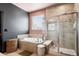 Bright bathroom featuring a soaking tub with tile surround, and glass enclosed shower at 12264 Olive Way, Thornton, CO 80602