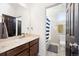 Bright bathroom with a large mirror, vanity sink, and a separate toilet and shower area at 12264 Olive Way, Thornton, CO 80602
