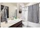 Bathroom featuring a vanity with granite counters and a shower/tub combo with modern fixtures at 12264 Olive Way, Thornton, CO 80602