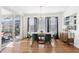 Bright dining room with a modern chandelier, glass table, and hardwood floors at 12264 Olive Way, Thornton, CO 80602