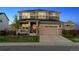 Charming two-story home boasts a 2-car garage, stone accents, and a manicured lawn at 12264 Olive Way, Thornton, CO 80602