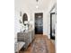 Inviting hallway with a decorative rug, stylish console table, and modern lighting at 12264 Olive Way, Thornton, CO 80602