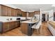 Modern kitchen with stainless steel appliances, custom cabinetry, a center island, and bar stool seating at 12264 Olive Way, Thornton, CO 80602