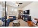 Cozy living room with comfortable seating, a ceiling fan, and a display cabinet at 12264 Olive Way, Thornton, CO 80602
