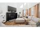 Bright living room boasting high ceilings, a cozy fireplace, and expansive windows for natural light at 12264 Olive Way, Thornton, CO 80602