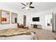 Spacious bedroom with fan, plush bed, and adjacent sitting area at 12264 Olive Way, Thornton, CO 80602