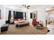 Spacious main bedroom with a comfortable bed, dark curtains, and a relaxing seating area at 12264 Olive Way, Thornton, CO 80602