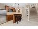 Charming basement bar area with wood cabinets, a microwave, and seating for entertaining at 1898 Wilson Cir, Erie, CO 80516