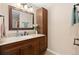 Elegant bathroom vanity with granite countertop, dark wood cabinetry, and modern fixtures at 1898 Wilson Cir, Erie, CO 80516