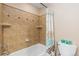 Bathroom featuring decorative shower tile, updated fixtures, and built-in shelving at 1898 Wilson Cir, Erie, CO 80516