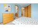 Bright bedroom features light blue walls, multiple doors, and a wood dresser at 1898 Wilson Cir, Erie, CO 80516