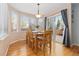 Dining area features natural light from bay windows, hardwood floors, and sliding door to a deck at 1898 Wilson Cir, Erie, CO 80516