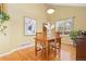 Dining room featuring a wooden table, hardwood floors, and natural light from a large window at 1898 Wilson Cir, Erie, CO 80516