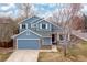 Charming two-story home with a blue exterior, brick accents and well-maintained landscaping at 1898 Wilson Cir, Erie, CO 80516