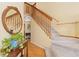 Hallway featuring hardwood floors, carpeted staircase, and a decorative table with a mirror at 1898 Wilson Cir, Erie, CO 80516