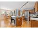 Bright kitchen features stainless appliances, hardwood floors, breakfast bar, and adjacent dining area at 1898 Wilson Cir, Erie, CO 80516