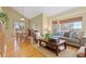 Open living room with hardwood floors, dining area, and large windows with exterior views at 1898 Wilson Cir, Erie, CO 80516