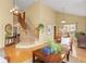 Inviting living room with hardwood floors, vaulted ceiling, staircase, and a large picture window at 1898 Wilson Cir, Erie, CO 80516