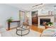 Cozy living room with a fireplace, hardwood floors, and a comfortable seating area at 1898 Wilson Cir, Erie, CO 80516