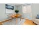 Bright office with hardwood floors, modern decor, and natural light, creating an ideal workspace at 1898 Wilson Cir, Erie, CO 80516