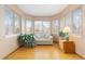 Bay window sitting area with hardwood floors, neutral walls, and a love seat at 1898 Wilson Cir, Erie, CO 80516