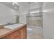 Well-lit bathroom with a single vanity, shower-tub combo, and neutral tile flooring at 1385 Candleglow St, Castle Rock, CO 80109