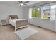 Sunlit bedroom with a large window, neutral carpet, and a cozy decor for a comfortable retreat at 1385 Candleglow St, Castle Rock, CO 80109