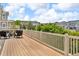 Inviting deck with white railing offering peaceful views of the green trees and community at 1385 Candleglow St, Castle Rock, CO 80109