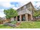 Beautiful home exterior featuring a covered patio with stone pillars and second story balcony at 1385 Candleglow St, Castle Rock, CO 80109