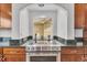 Modern kitchen with stainless steel oven and cooktop, granite countertops and custom wooden cabinets at 1385 Candleglow St, Castle Rock, CO 80109