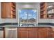 Well-lit kitchen sink area with a view of the backyard, stainless steel appliances, and modern cabinets at 1385 Candleglow St, Castle Rock, CO 80109