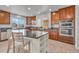 Modern kitchen with stainless steel appliances, a center island, granite countertops, and ample cabinet space at 1385 Candleglow St, Castle Rock, CO 80109
