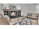 Cozy living room showcasing a stone fireplace, plush seating, neutral decor, and lots of natural light at 1385 Candleglow St, Castle Rock, CO 80109