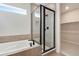 Bathroom with glass enclosed shower, soaker tub and a view into the walk-in closet at 24661 E 33Rd Dr, Aurora, CO 80019