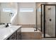 Bright bathroom with soaking tub, glass shower, and stylish black fixtures at 24661 E 33Rd Dr, Aurora, CO 80019