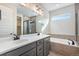 Elegant bathroom featuring a double sink vanity and a separate glass-enclosed shower at 24661 E 33Rd Dr, Aurora, CO 80019