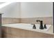 Close-up of a bathroom with a soaking tub and dark bronze fixtures at 24661 E 33Rd Dr, Aurora, CO 80019