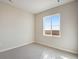 Bedroom with large window and light grey carpeting at 24661 E 33Rd Dr, Aurora, CO 80019