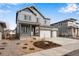 A two-story gray home with a two car garage, covered porch, stone accents, and newly installed landscaping at 24661 E 33Rd Dr, Aurora, CO 80019