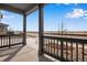 View from the front porch showing pillars, a small landscape area, and the street in front of the home at 24661 E 33Rd Dr, Aurora, CO 80019