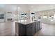 Modern open kitchen featuring an island with bar seating, and stainless appliances at 24661 E 33Rd Dr, Aurora, CO 80019