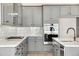 Well-equipped kitchen featuring gray cabinets, stainless steel appliances, and granite countertops at 24661 E 33Rd Dr, Aurora, CO 80019